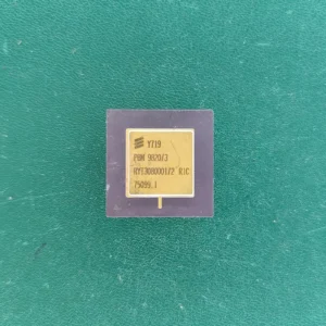 Ericsson PBM 9820/3 gold ceramic IC with ruler on green background