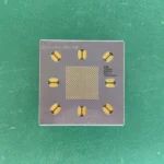 LSI Logic LS4885 ceramic PGA substrate with gold pads on a green background.