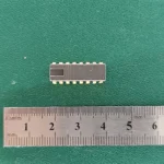 MF1101 IC with gold pins and ruler on green background
