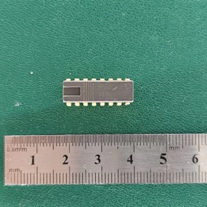MF1101 IC with gold pins and ruler on green background