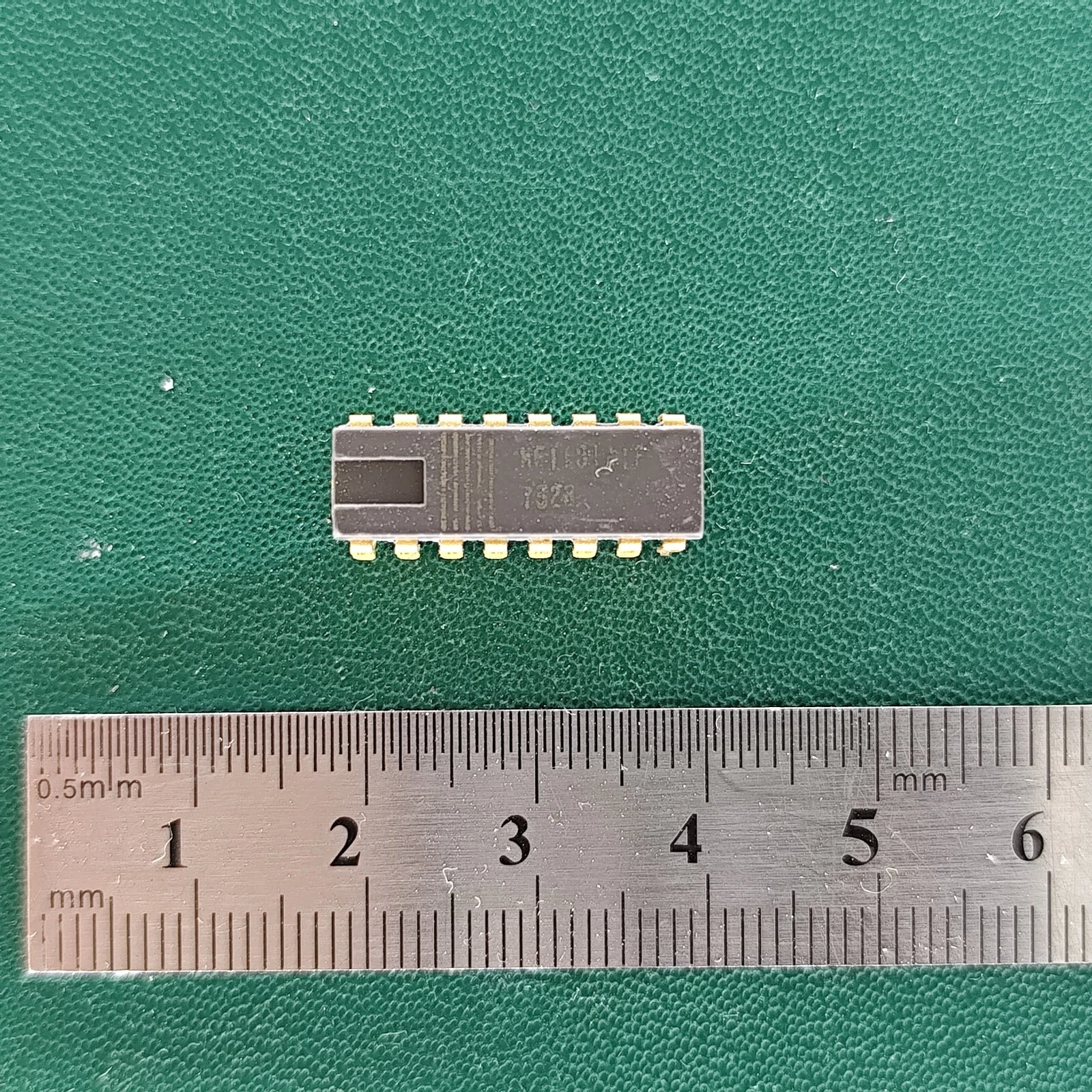 image_3 MF1101 IC with gold pins and ruler on green background