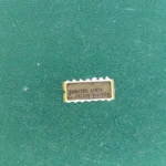 2N7334 JANTX ceramic IC with gold pins on green background
