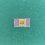 8702CN ceramic IC with gold top and gold pins on green background