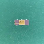 Signetics 2101A-4 ceramic RAM IC with gold top on green background