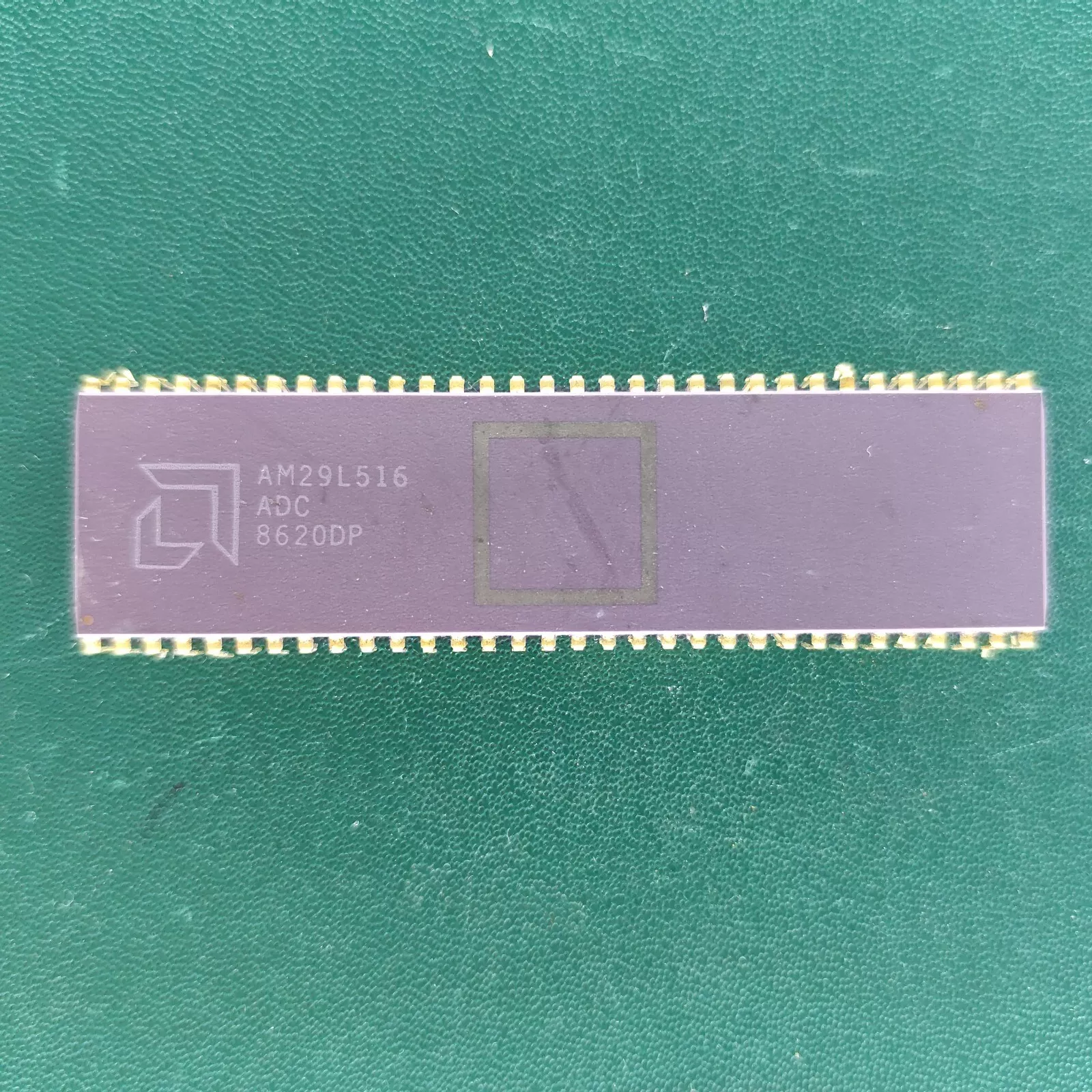 image_3 AMD AM29L516 long ceramic DIP IC with gold pins on green background