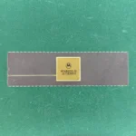 Motorola MC68000L10 long ceramic CPU with gold top and gold pins on green background