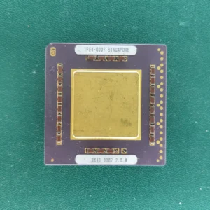 HP 1FE4-0007 ceramic CPU substrate with a large gold top plate on a green background.
