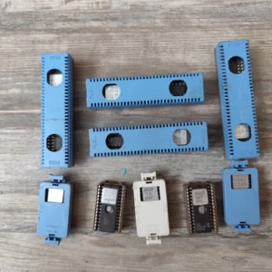 9 ACDelco ECM ECU EPROM chips with blue and white ZIF sockets