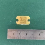 Gold ceramic RF power transistor 3485P2-02 from Japan with ruler for scale